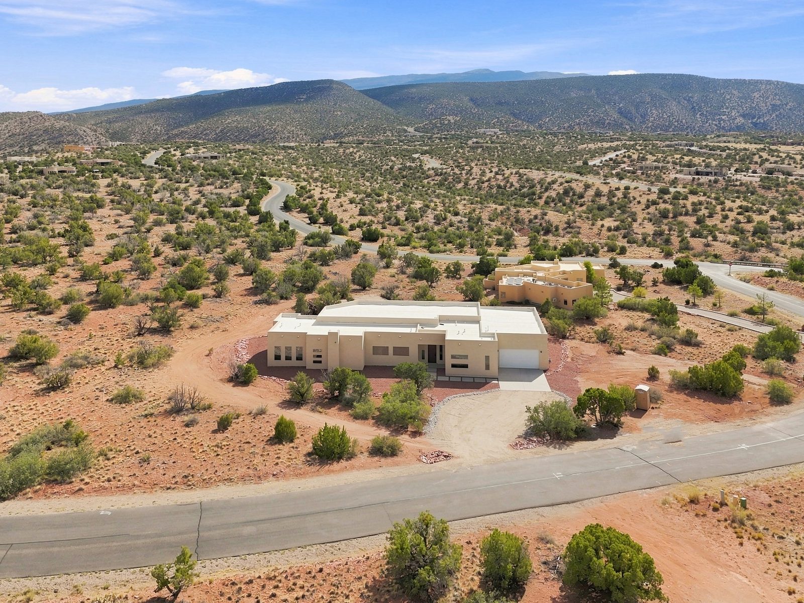 Pueblo-style custom home aerial view in Placitas NM by Solano Builders